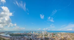 Panoramic view of Cartagena de Indias, showing the Bay, Bocagrande, the Historic Center and the island of Tierra Bomba under a deep blue sky that contrasts with the Caribbean Sea.